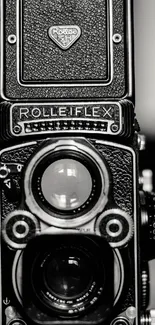 Close-up of a vintage Rolleiflex camera in black and white.