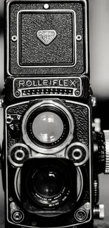Monochrome close-up of a vintage camera, displaying intricate details.