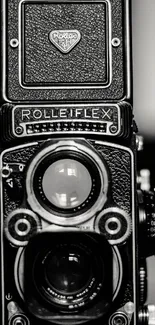 Close-up of a vintage Rolleiflex camera in black and white.