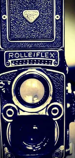 Vintage Rolleiflex camera in navy blue tones for mobile wallpaper.