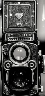 Black and white vintage Rolleiflex camera wallpaper with yellow text.