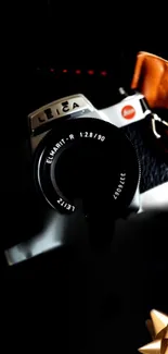 Vintage Leica camera with artistic shadow effects in dark tones.