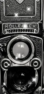 Vintage black and white camera with a sparkling effect in focus.