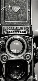 Vintage Rolleiflex camera with sparkles on a black background.