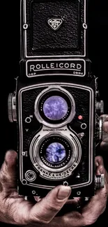 Vintage Rolleicord camera held in hand.