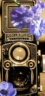 Vintage camera adorned with vibrant purple flowers on a sepia background.