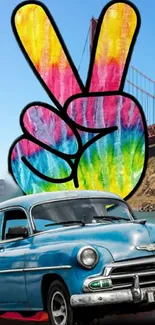 Vintage car with colorful peace sign art in front of landmark bridge.