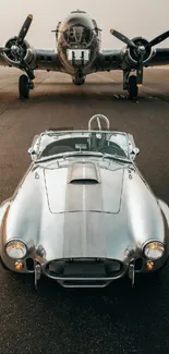 Vintage car with a classic airplane on the runway.