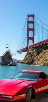 Vintage red car near Golden Gate Bridge under blue sky.