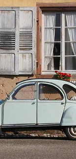 Vintage car parked by a rustic house.