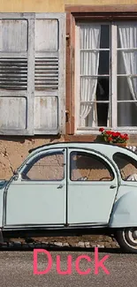 Vintage car parked in front of a rustic building with beige walls.