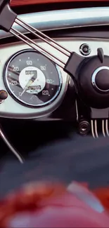 Close-up of a vintage car dashboard and steering wheel.