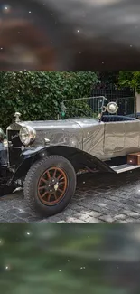 Vintage car parked on cobblestone street with greenery backdrop.