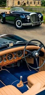 Interior view of a classic convertible car with a vintage roadster in the background.