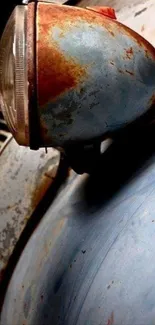 Close-up of vintage car headlight with rusty texture.