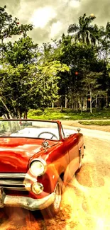 Vintage red car on a countryside road with greenery and dramatic sky.