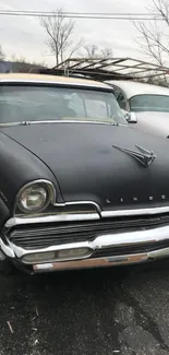 Vintage gray car parked outdoors, showcasing classic design.