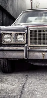 Vintage car parked in an urban setting with a focus on headlights and grill.