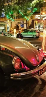 Vintage Volkswagen Beetle at night, adorned with colorful city lights and reflections.