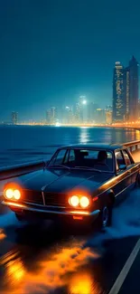 Vintage car driving along a city coastal road at night with city lights.