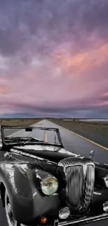 Vintage car on an open road with a dramatic purple sky.