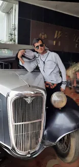 Man leaning on a vintage car with stylish decor