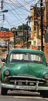 Vintage green car on a vibrant urban street, perfect for mobile wallpaper.