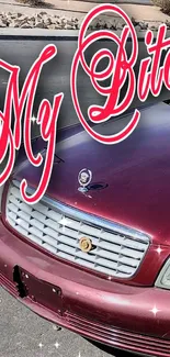 Vintage car parked on street with red design and bold text.