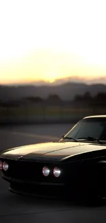 Silhouette of a vintage car at sunset with a dark, moody ambiance.