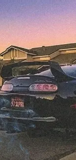 Vintage sports car at sunset with a purple sky backdrop.