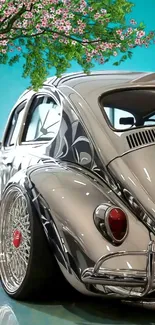 Vintage car with blossom tree and sky in background.