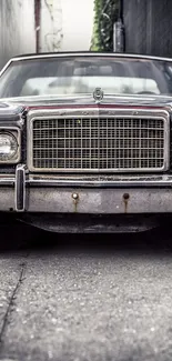 Classic vintage car parked in a narrow, dark alleyway.