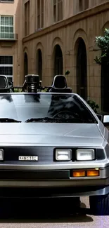 Front view of a silver vintage car in an urban setting.