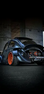 Vintage car with orange wheels under a bridge in an urban setting.