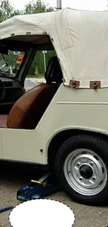 Vintage car with white canopy in a detailed wallpaper view.