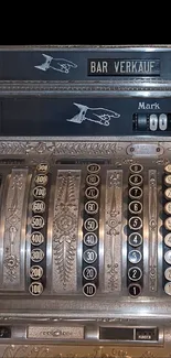 Vintage cash register with intricate detailing and metal design.