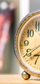 Close-up of a vintage clock against a blurred background, perfect for a classic wallpaper.