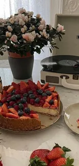 Vintage scene with cheesecake, strawberries, and a vinyl player, set on a table.