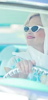 Woman in sunglasses, driving a vintage car, pastel blue tones.