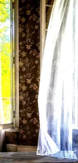 Vintage window with floral wallpaper and sheer curtains.