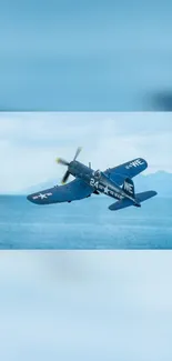 Vintage fighter jet flying in a blue sky over the ocean.