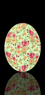 Egg-shaped floral design with roses on a mint green background against black.