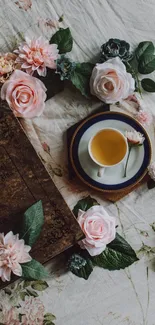 Vintage floral tea scene with roses and a cup on a delicate cloth.