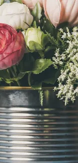 Vintage floral wallpaper with pink and white flowers in a metal tin.