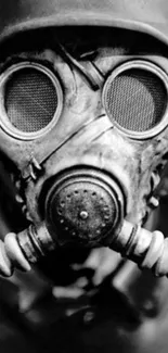 Black and white image of a vintage gas mask with a helmet.