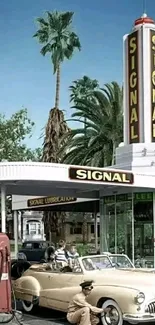 Vintage gas station with retro car and palm trees in the background.