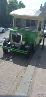 Vintage green bus parked on a bustling city street.