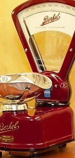 Vintage Berkel kitchen scale with red design on yellow background.