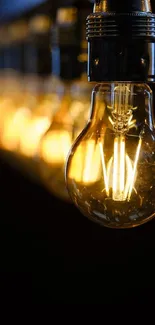 Vintage lightbulb with warm golden glow, ideal for aesthetic wallpapers.