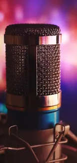 Close-up of a vintage microphone with a blurred colorful background.